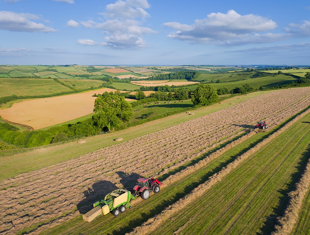 aerial view of tractors baling hay